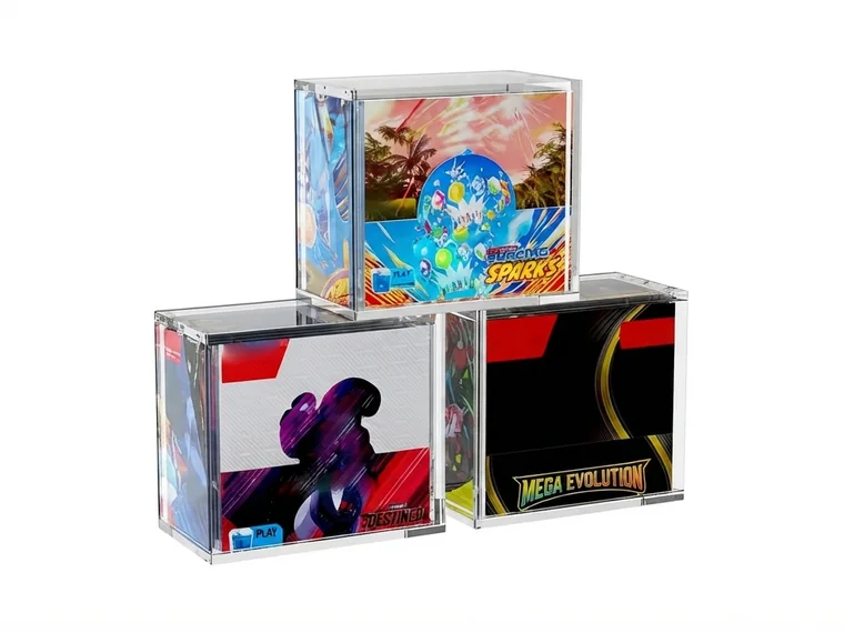 Three clear acrylic blocks printed with full-color artwork and covers, standing on a pale surface
