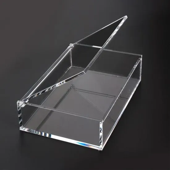 A clear acrylic box with its lid tilted open on a black background, light running along the polished edges and through the wall