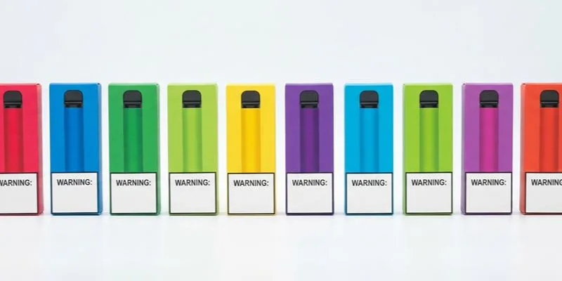 Ten printed vape cartons in different flavor colors with identical warning panels