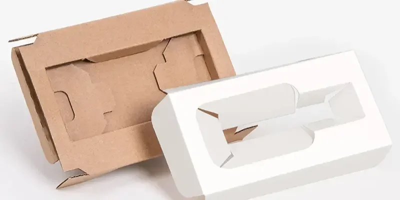 A kraft cardboard cutout insert beside a white layered cutout insert