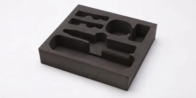 A dark high-density EVA foam tray with die-cut pod cavities