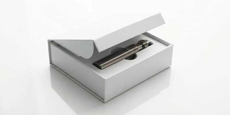 A white dummy vape box with an open lid and a vape pen seated in the insert cavity