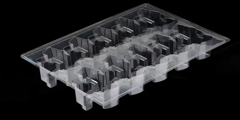 A clear vacuum-formed PETG blister tray with molded pod cavities