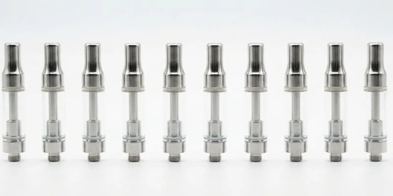 Ten metal vape cartridges lined up in a row for dimensional consistency checks