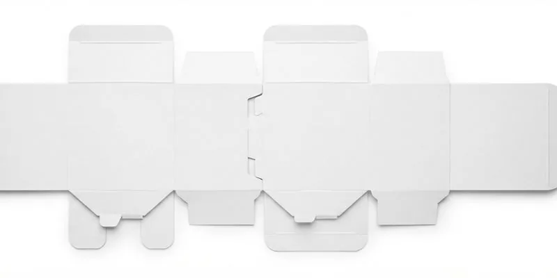 Flat white die-cut box blanks laid out in a row