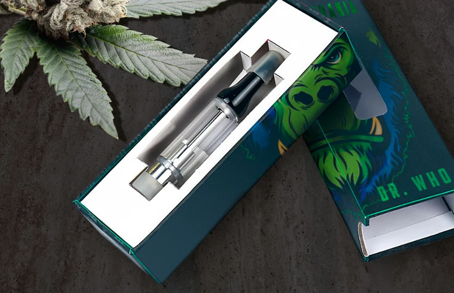 A compact pen in its printed slide box
