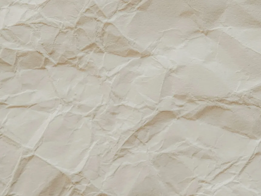 A sheet of natural uncoated kraft paper with visible fibre