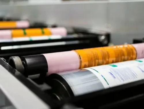 Printed colour swatch charts fanned out after a flexographic run