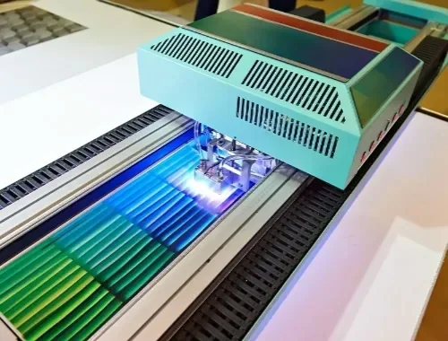 A printed sheet curing under UV lamps on a press