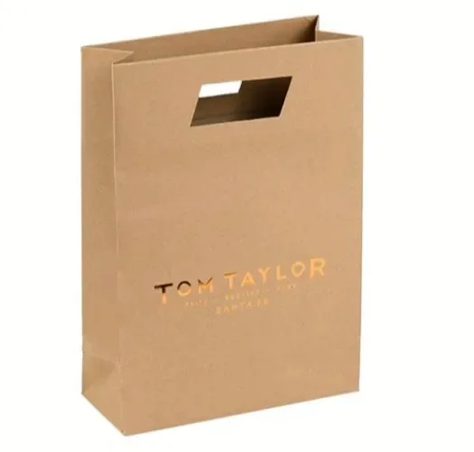 A kraft bag with an integrated die-cut handle and a printed fashion logo