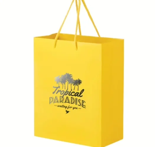 A yellow paper tote bag with rope handles printed with a tropical resort logo