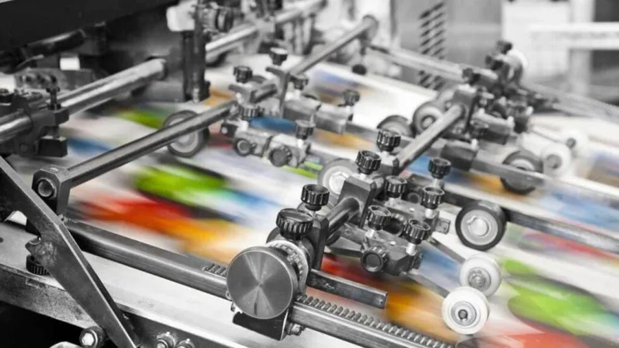 An offset press running printed sheets