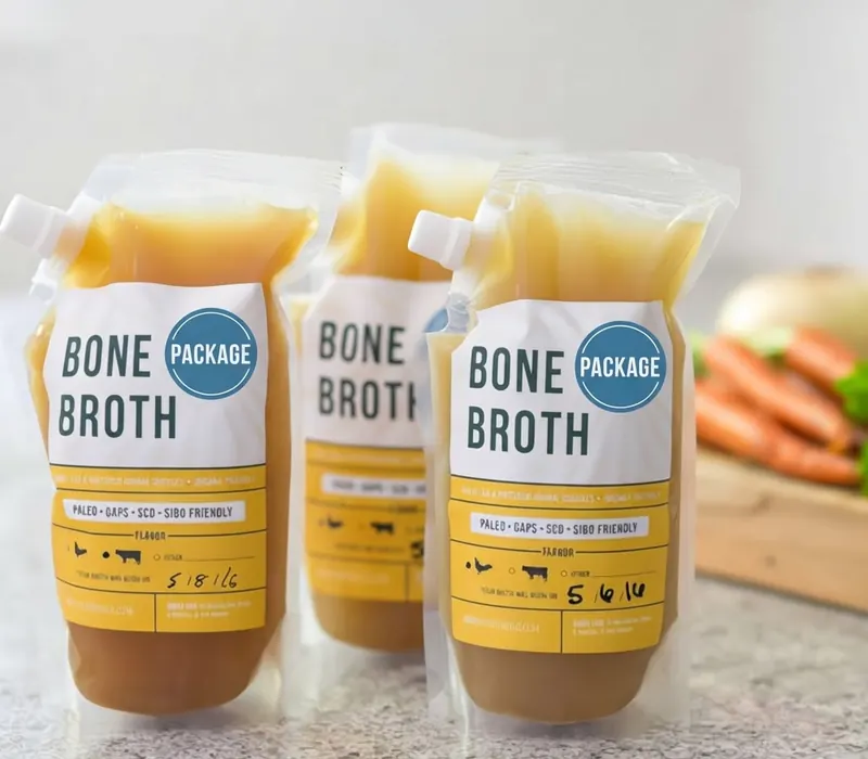Bone broth pouches with fitted spouts standing in a row