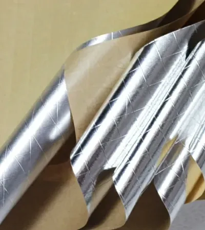 Layers of kraft paper and metal foil stacked to show the laminate build