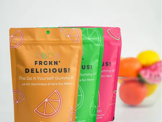 Three brightly printed stand-up pouches in a row, standing upright