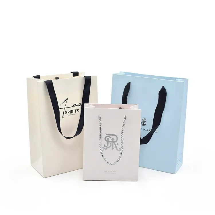 Cream, blush and pale blue gift bags with woven rope handles and printed branding
