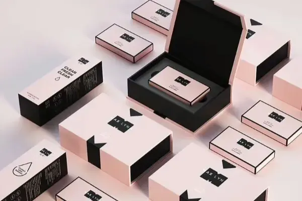 Several black and white rigid boxes, one open to show a foam insert holding a tray