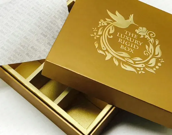 A gold foil-stamped rigid box and its matching tray