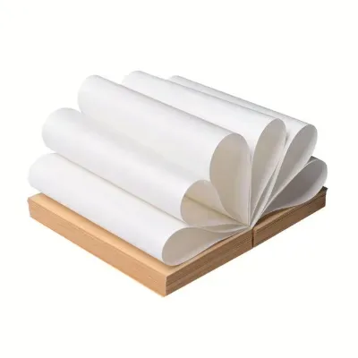 A fanned stack of white kraft paper on a wooden block