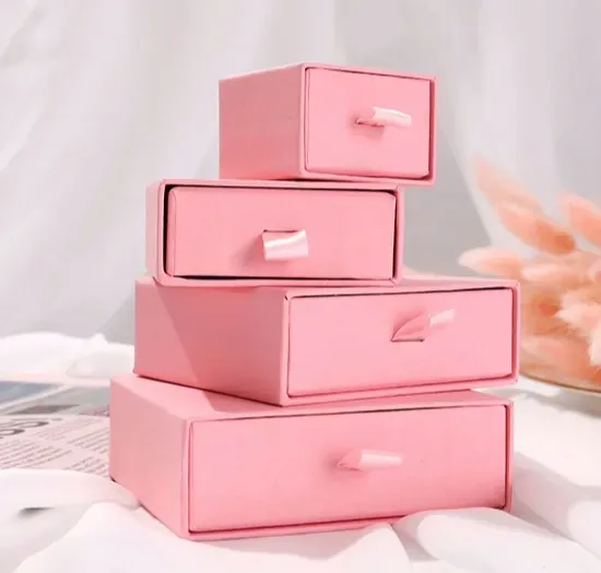 A stack of pink drawer boxes, each with a ribbon pull on the drawer front