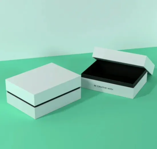 A white and a black two-piece rigid box with their lids resting beside them